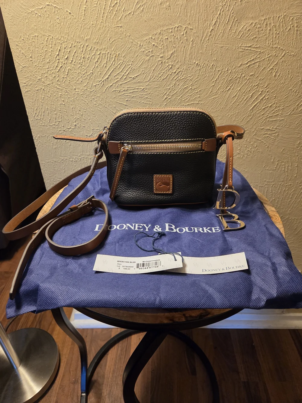 Dooney & Bourke NWT Black Pebble Leather Crossbody with Brown Trim. Logo charms